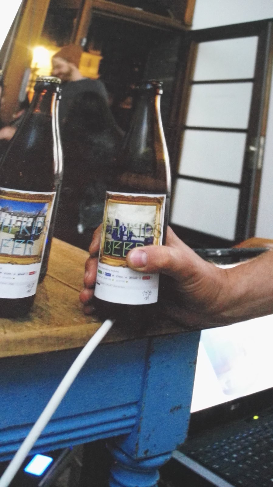A hand holding a bottle