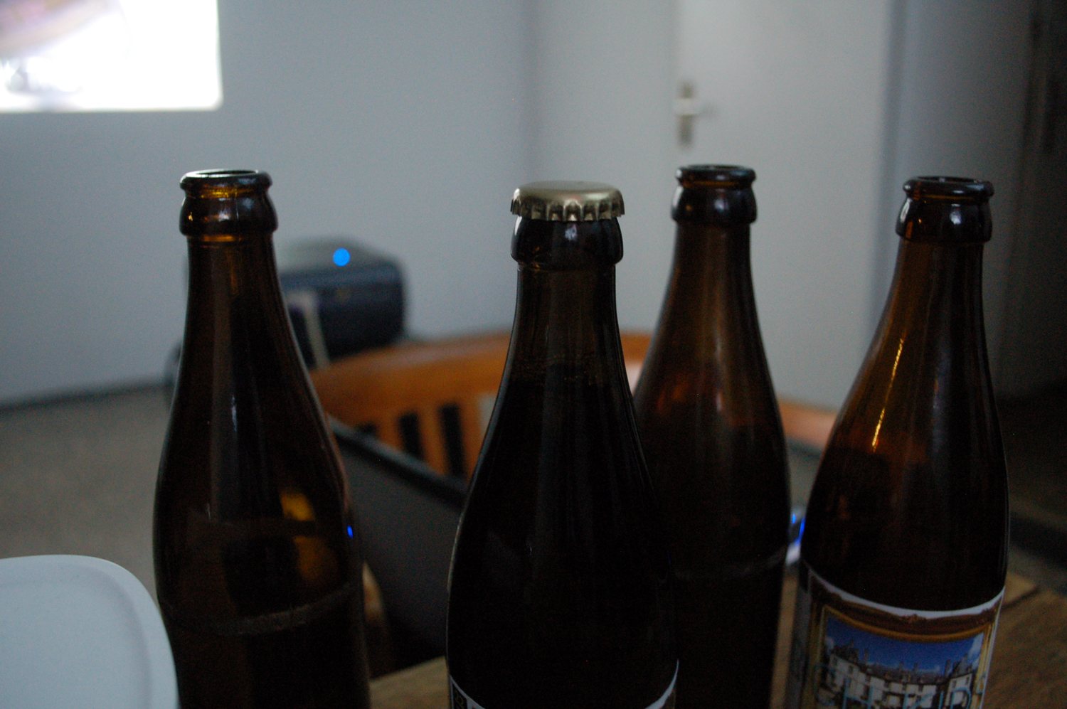 Bottles standing in the white gallery space